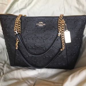 Large embossed black Coach tote with gold chains